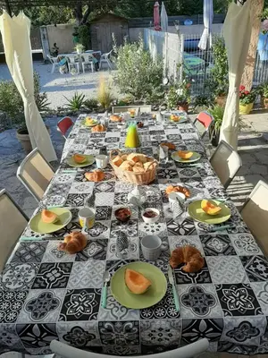 a table with plates of food on top at le Mas d'Hubert in LʼIsle-sur-la-Sorgue