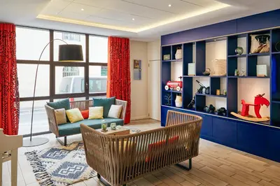 a restaurant with tables and chairs and windows at Aparthotel Adagio Aix-en-Provence Centre in Aix-en-Provence