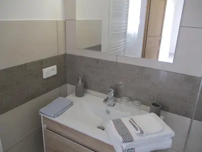 a bathroom with a sink and a mirror at LA MAGUETTE in Sault-de-Vaucluse