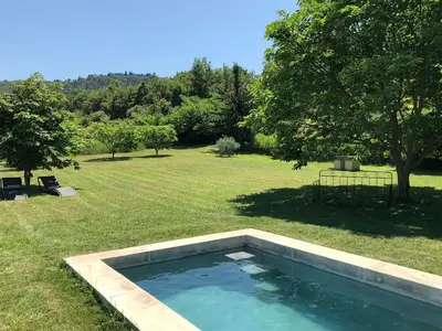 a swimming pool in the middle of a yard at La Magnanerie in Bonnieux