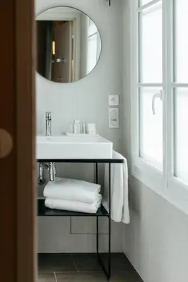 a bathroom with a white sink and a mirror at Hôtel Boutique Cézanne centre Aix-en-Provence in Aix-en-Provence