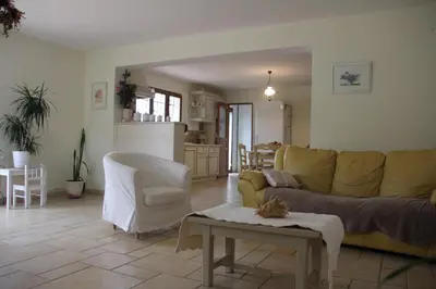 a living room with a yellow couch and a table at Domaine de la Marie dans le Luberon in Peypin-dʼAigues