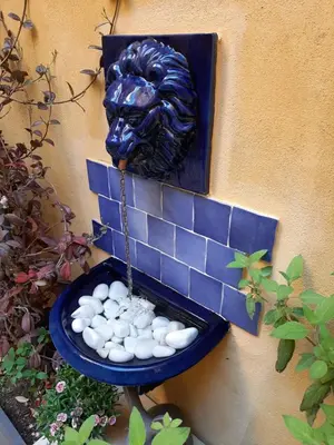 a statue of a lion with a bowl of rocks at Cent Cinq - unique apartments in the heart of Apt in Apt