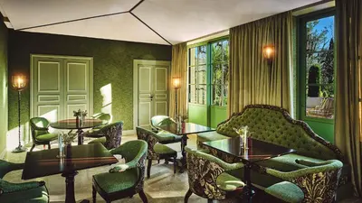 a restaurant with tables and chairs and windows at Le Pigonnet - Esprit de France in Aix-en-Provence