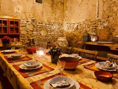 a table with plates of food and wine glasses at Château de la Merletade in Cheval-Blanc