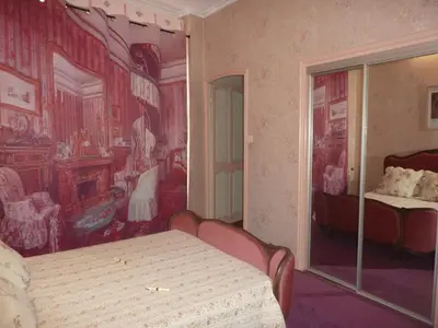 a bedroom with a painting on the wall and a bed at Hôtel du Fiacre in Carpentras