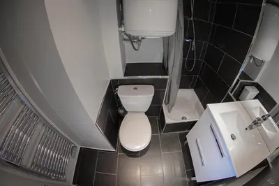 a small bathroom with a toilet and a sink at Séjours & Affaires Aix-en-Provence Mirabeau in Aix-en-Provence