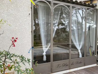a gazebo with white curtains on it at Le Mas des Roches à Velaux in Velaux