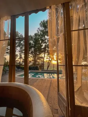 a room with a window with a view of a pool at Le Mas des Roches à Velaux in Velaux