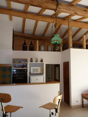 a kitchen with a stove and a microwave at Le Jas de Verdolier in Sault-de-Vaucluse