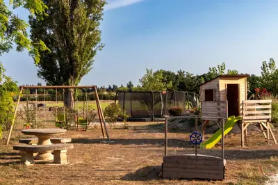 a playground with a picnic table and a bench at Mas Le 7 in Saint-Andiol