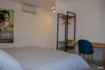 a bedroom with a bed and a desk with a blue chair at BASTIDE 7 in La Fare-les-Oliviers
