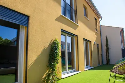 a building with a plant on the side of it at BASTIDE 7 in La Fare-les-Oliviers