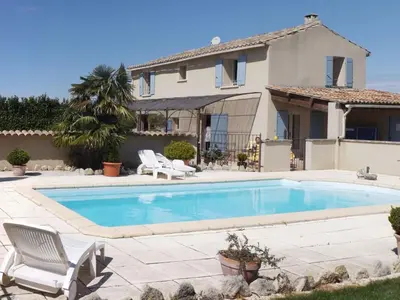 a swimming pool in front of a house at Demeure d'hôtes et Mas Maurice in Oppède