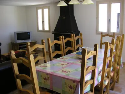 a dining room with a table and chairs and a fireplace at Demeure d'hôtes et Mas Maurice in Oppède