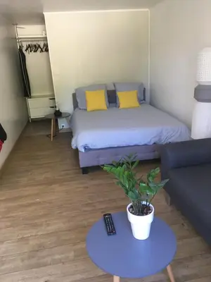 a room with a bed and a couch and a table at T2 de la Bastide Rouge vue exceptionnelle (180°) sur Aix domaine privé T2 indépendant de 37 m2 avec terrasse exposée plein sud Piscine 10 X 5 in Aix-en-Provence