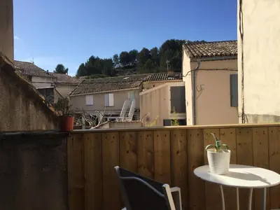 a balcony with a table and chairs on a fence at T2 avec TERRASSE, CLIM , box fibre in Vedène