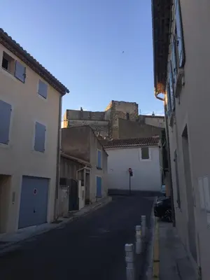 an alley with buildings and a castle in the background at T2 avec TERRASSE, CLIM , box fibre in Vedène