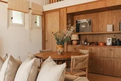 a dining room with a table and a tv at Capelongue, a Beaumier hotel & Spa in Bonnieux