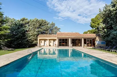 a house with a swimming pool in front of a house at Best Western Domaine de Roquerousse in Salon-de-Provence