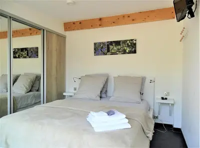 a bedroom with a bed with towels on it at Gîte et maison de vacances Campagne Valérie in Aix-en-Provence