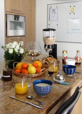 a kitchen counter with a bunch of fruit and a blender at Gîte et maison de vacances Campagne Valérie in Aix-en-Provence