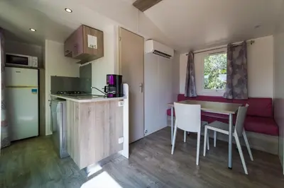 a floor plan of a small house with a stove at Camping Les Hautes Prairies in Lourmarin