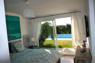 a bedroom with a bed and a sliding glass door at Villa élégante à Villelaure + Clim in Villelaure