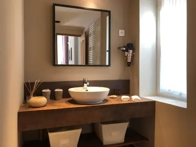 a bathroom with a sink and a mirror at MAISON LUBERON in Apt