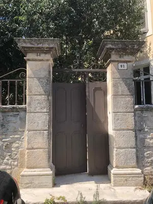 a large brown door with the number on it at MAISON LUBERON in Apt