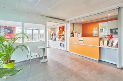 a room with a counter and a table in a store at Premiere Classe Avignon Parc Des Expositions in Montfavet