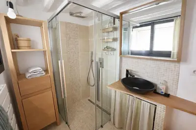 a bathroom with a glass shower and a sink at Toits Vieil Aix - Appartement de charme avec terrasse d'exception centre ville historique proche Cardeurs Et Mairie in Aix-en-Provence