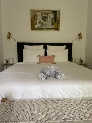 a bed with a stuffed animal laying on it at Château de Saint-Girons - Luxury Guest House in Provence in Aix-en-Provence