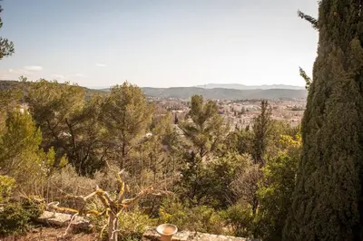 a view of a city from a hill with trees at Suite l'Escoundudo in Aix-en-Provence