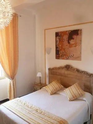 a bedroom with a bed with two pillows on it at Hotel Toppin in Cavaillon