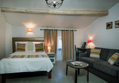 a bedroom with a bed and a couch at Hotel Toppin in Cavaillon