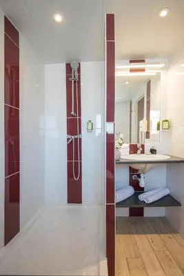 a bathroom with a shower and a sink at Hotel du Forum in Carpentras