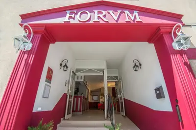 a red and white front door of a forney store at Hotel du Forum in Carpentras