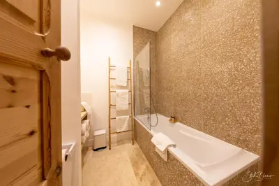 a bathroom with a bath tub and a shower at Moulin de la Roque in Althen-des-Paluds