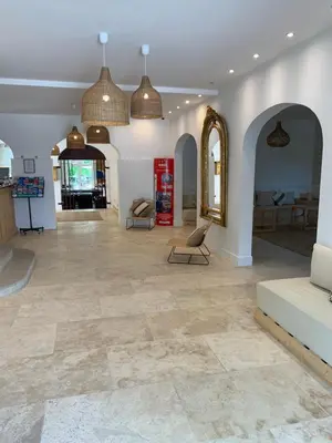 a large living room with a large tile floor at Moulin de la Roque in Althen-des-Paluds