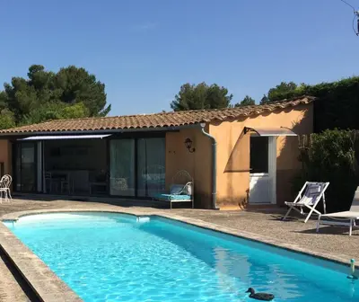 a swimming pool in front of a house at L'ATELIER JONQUERETTES in Jonquerettes