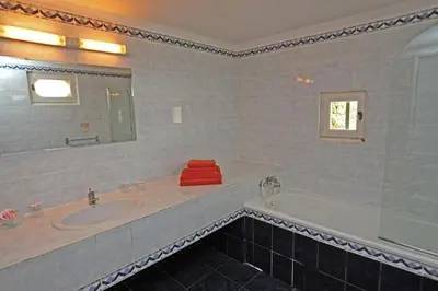 a bathroom with a tub and a sink and a mirror at Mas De La Tour in Gargas