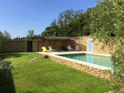 a backyard with a swimming pool and a house at typical provencal bastide, built of local stones, in the luberon in cheval-blanc with secured pool and wifi -sleeps 6 people. in Cheval-Blanc