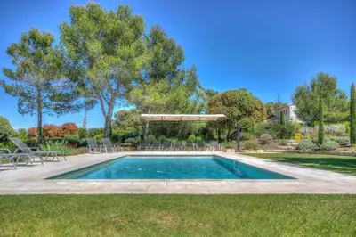 a swimming pool in a yard with a gazebo at Mas Santoline in Eygalières
