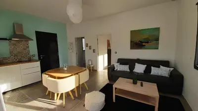 a living room with a couch and a table at Villa Quatra aux portes d'Aix-en-Provence in Éguilles
