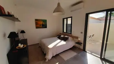 a bedroom with a bed and a large window at Villa Quatra aux portes d'Aix-en-Provence in Éguilles