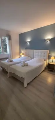 a bedroom with a large white bed in a room at Gîte Charmant avec Piscine et Terrasse en Provence MDV in Carpentras