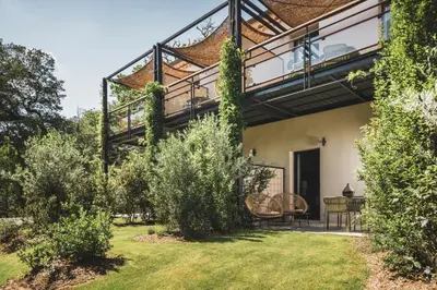 an external view of a house with a balcony at Les Lodges Sainte-Victoire Hotel & Spa in Aix-en-Provence