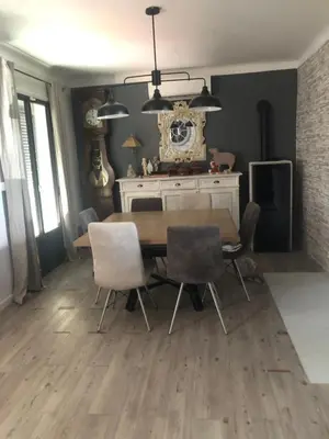 a dining room with a wooden table and chairs at Centre d'énergies in Monteux