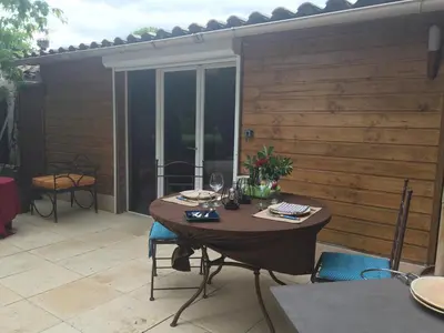 a table and chairs on a patio at DEPENDANCE PRIVEE - HALTE ROUTE in Le Thor